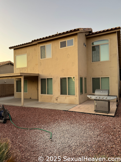 The back patio with things pulled away from it.