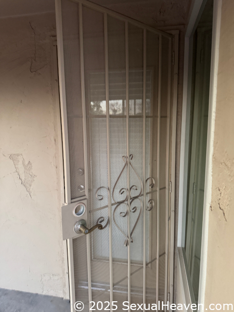 An open screen door without a deadbolt.