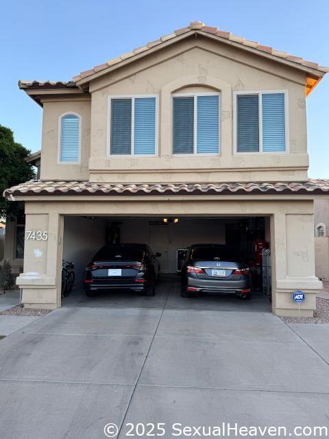The front of the house with an open garage.