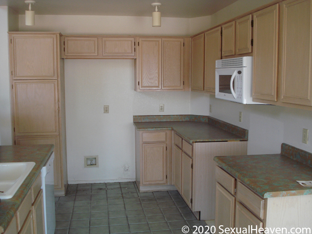 An old kitchen with green tile.