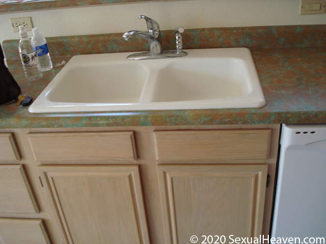 A top mount white kitchen sink.
