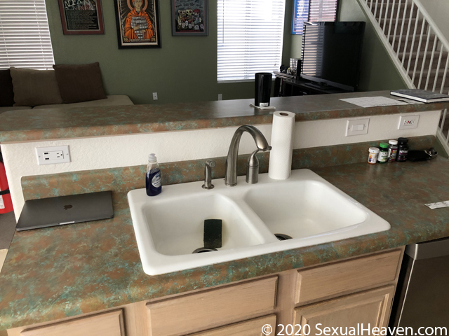 A two tier kitchen island with sink.