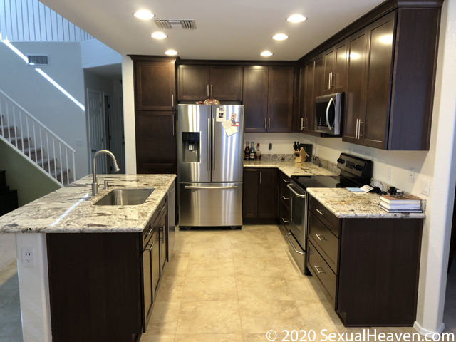 A kitchen with granite countertops.