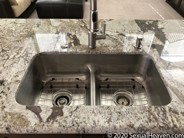 An undermount kitchen sink set in granite.