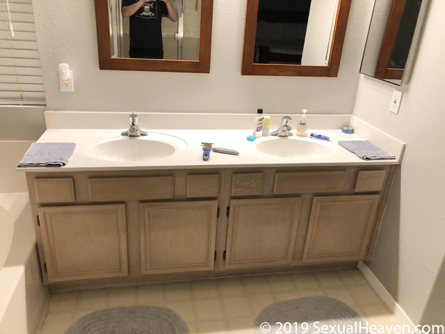 A bathroom vanity and mirrors.