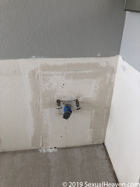 Drywall repair around sink valves.