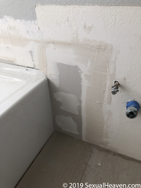 Drywall repair around a tub.