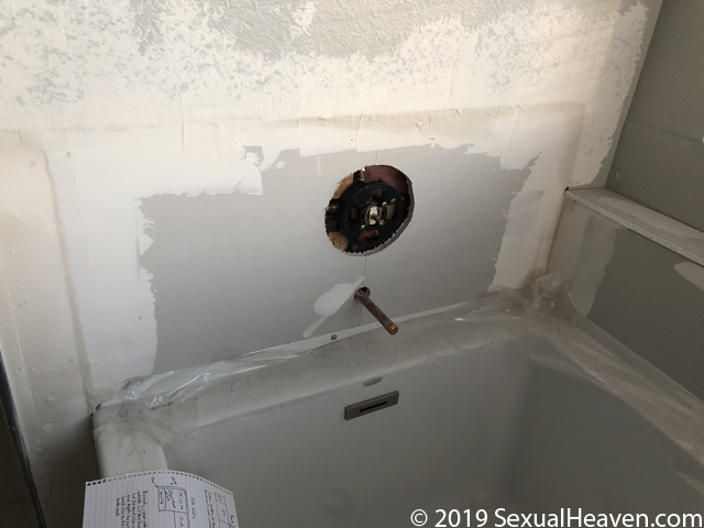 Drywall repair around the new tub valve.