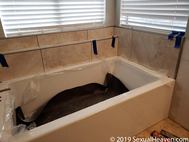A tub with tile being installed.