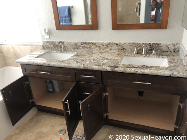 A vanity with a granite countertop.