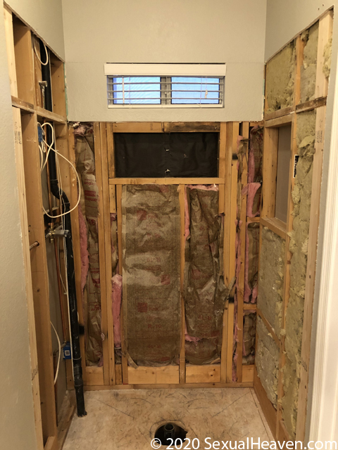 A bathroom with the vanity and tub removed.