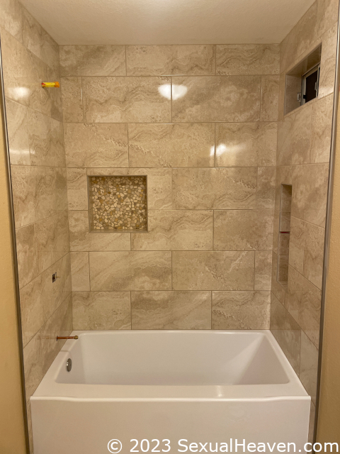 A fully tiled tub surround.