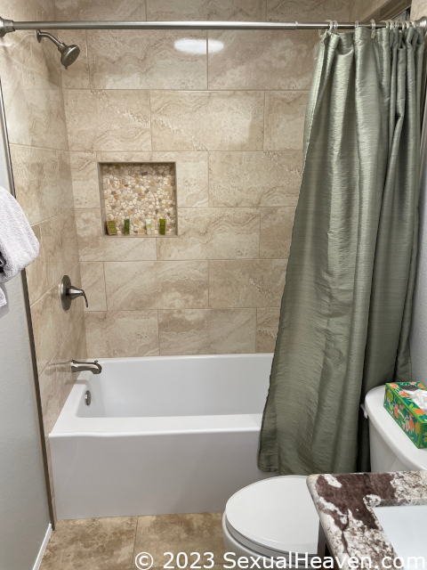 A tiled shower surround.